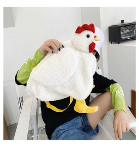 Detailed view of plush chicken cross-body bag with textured lamb wool and yellow strap