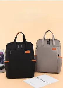 Detail view of stylish oxford laptop backpack in black and grey with brown accents