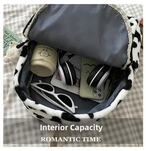 Macro view of plush cow print backpack interior showcasing its large storage capacity
