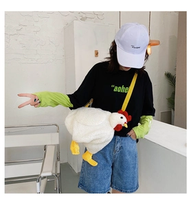 Detail of cute white plush chicken crossbody bag featuring yellow straps and chicken legs