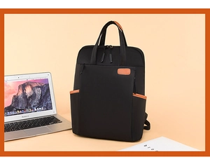 Close-up of black oxford backpack with leather details holding a laptop and books