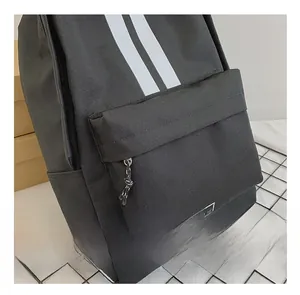 Detail showing durable black canvas fabric and white parallel stripes on casual backpack