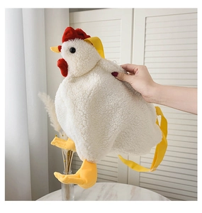Detail of cute white plush chicken bag with soft fleece texture and red comb accents