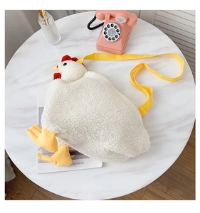 Detail of cute white plush chicken bag with yellow nylon strap and red comb texture