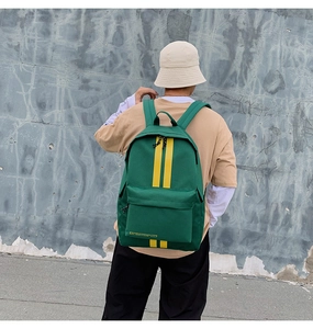 Fashionable dark green canvas backpack with vibrant yellow straps for travel and school