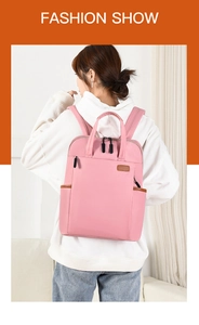 Close-up of pink Oxford cloth backpack with reinforced brown leather side trim details
