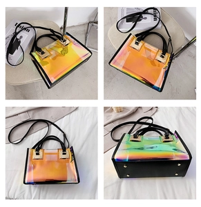 Detail view of laser holographic handbag with black trim and gold hardware accents