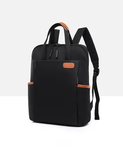 Close-up of black oxford cloth laptop backpack with brown leather handle details