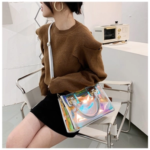 Close-up of laser iridescent PVC handbag with metal hardware and thin shoulder strap