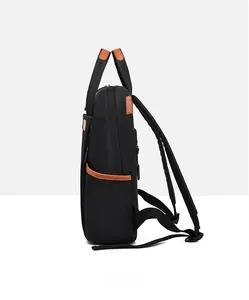 Side view of black Oxford cloth backpack with leather trim and padded shoulder straps