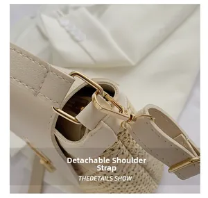 Detail view of lychee-grain faux leather stitching and gold metal buckle on woven bag