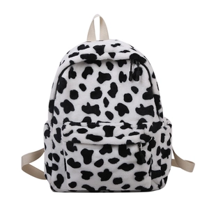 Cute cow print plush backpack for women featuring soft faux fur and adjustable straps