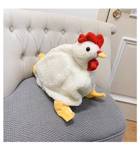 Close-up of a plush chicken bag on a gray sofa showing soft white fleece material