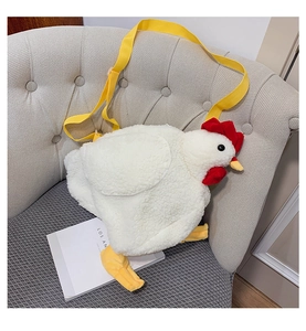 Detail of soft white plush chicken bag with yellow strap on a minimalist chair