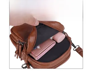 Detail view of multi-pocket dark brown crossbody bag showing spacious inner compartments