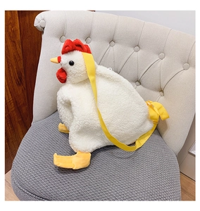 Detail showing the white plush chicken bag with soft fleece texture and yellow strap