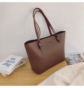 Détail du grand sac cabas marron foncé avec texte FASHION et finitions métalliques