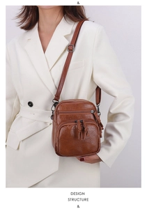 Brown vintage faux leather crossbody bag with multiple zippers and stylish fringe details
