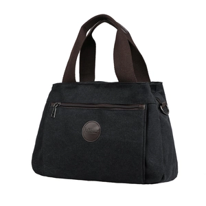 Retro canvas travel duffel bag with large capacity and brown woven handles in black