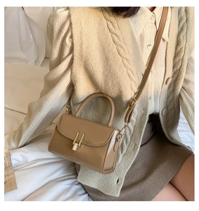 Detail of khaki retro square bag with golden H-buckle and adjustable shoulder strap