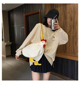 Detailed close-up of a white plush chicken crossbody bag with soft faux fur and yellow strap