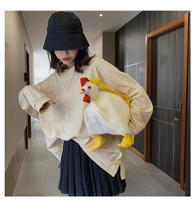 Detailed view of the cute white plush chicken crossbody bag with yellow straps on a model