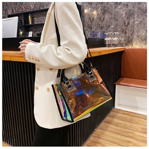 Holographic PVC tote bag detail showing iridescent rainbow finish and black handle straps