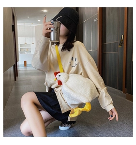 Detail view of the plush white chicken bag with yellow straps and soft lamb wool texture
