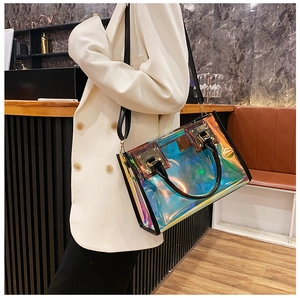 Close-up of translucent laser tote bag with colorful gradient effects and black leather handles