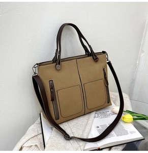 Detail of khaki frosted leather tote bag with dual pockets and shoulder straps