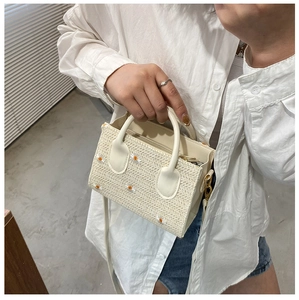 Détail du sac cabas en paille blanche avec broderie marguerite et bandoulière réglable