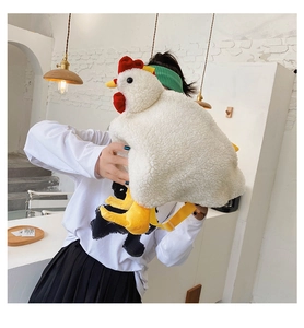 Detail of the white plush chicken crossbody bag with yellow adjustable shoulder strap