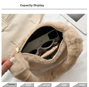 Détail de la capacité du sac à main en peluche beige avec fermeture éclair dorée