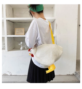 Detail view of a cute chicken plush bag with soft white faux fur and a yellow strap