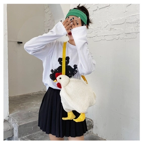 Detail of creative plush chicken crossbody bag showing white fleece texture and yellow straps