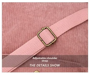 Detail of adjustable pink corduroy shoulder strap with high-quality bronze metal buckle