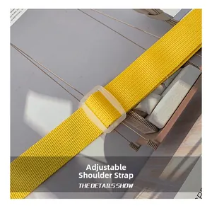 Detail of a bright yellow woven adjustable shoulder strap with a clear plastic buckle