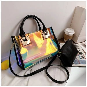 Detail of laser iridescent tote bag featuring black handles and matching inner pouch