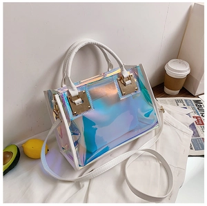 Macro detail of holographic PVC tote bag with white lychee leather handle and gold hardware