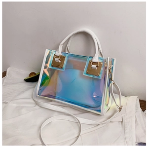 Detail of laser holographic transparent handbag with white leather handles and gold hardware