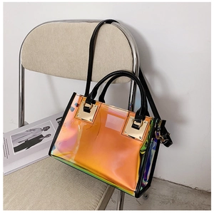 Detail of holographic PVC tote bag with black handles on a beige velvet chair