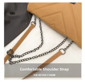Detail of khaki quilted crossbody bag featuring metal chain and PU leather shoulder strap