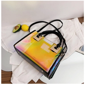 Detail of laser iridescent handbag with black leather trim and gold metal lock clasp
