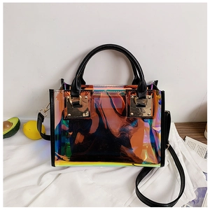 Detailed view of iridescent laser PVC handbag with black leather straps and gold buckle