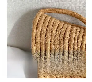 Detail of the high-quality woven texture and neat stitching on a straw bucket bag