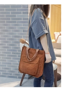 Caramel brown corduroy tote bag shown in a lifestyle street style outfit setting