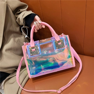 Holographic pink transparent tote bag with adjustable strap shown on a sofa