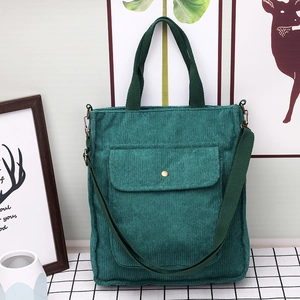 Dark green corduroy tote bag with front button pocket for versatile crossbody use