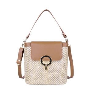 Handwoven straw bucket bag with brown faux leather trim and golden metal ring
