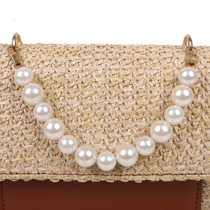 Minimalist woven straw handbag with pearl handle and brown leather base splicing